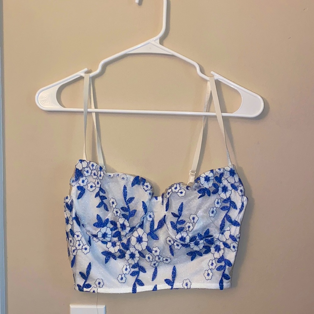 White top with blue flowers